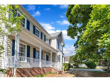 Charming two-story home featuring a welcoming front porch and blue shutters at 206 Wagon Trail Dr, Cary, NC 27513