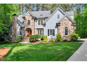 Elegant two-story home boasting stone accents, manicured lawn, and inviting curb appeal at 2201 Avinshire Pl, Wake Forest, NC 27587
