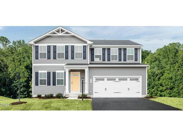Charming two-story home with gray siding, black shutters, and a two-car garage at 294 N Coral Bells Way, Four Oaks, NC 27524