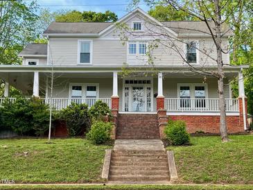 Charming two-story home with a welcoming front porch and landscaped front yard at 330 W King St, Hillsborough, NC 27278