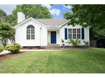 Charming one-story home featuring a well-manicured lawn, blue shutters, and a lovely front door at 3521 Piedmont Dr, Raleigh, NC 27604