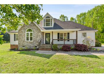 Charming home with stone facade, dormer window and covered front porch at 5525 Sandy Trail Dr, Knightdale, NC 27545