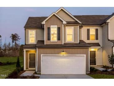 Charming two-story home featuring a attached garage and inviting curb appeal at 718 Colby Pl, Durham, NC 27713