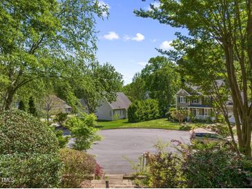 A lush residential neighborhood with sidewalks, mature trees, and well-maintained homes creating a peaceful atmosphere at 102 Treadwell Ct, Cary, NC 27513