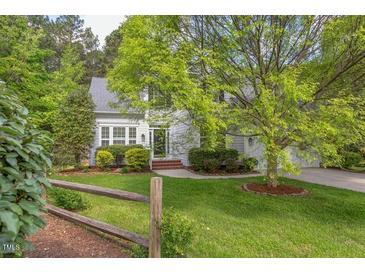 Charming two-story home with beautiful landscaping and a split rail fence at 1311 Antler Point Dr, Durham, NC 27713