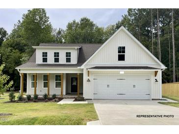 Charming two-story home featuring a covered front porch and a two-car garage at 200 Pretty Run Branch Ln, Wendell, NC 27591