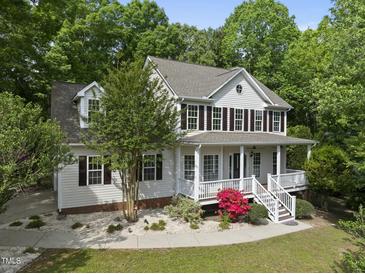 Charming two-story home with a welcoming front porch and beautiful landscaping at 204 Black Forest Dr, Clayton, NC 27527