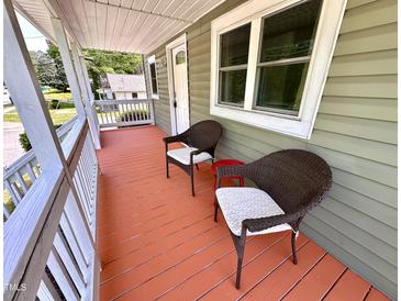 Inviting front porch featuring two wicker chairs and painted wood flooring at 2101 S Roxboro St, Durham, NC 27707