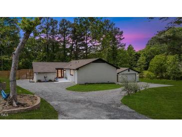 Charming single story home with fresh white paint and a gravel driveway at 226 Smith Dr, Durham, NC 27712