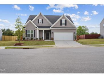 Charming two-story home with a manicured lawn, attached garage, and welcoming entrance, perfect for a growing Gathering at 270 Oak Park Blvd, Youngsville, NC 27596
