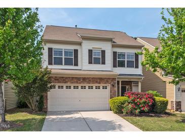 Charming two-story home featuring a brick-accented garage and well-maintained landscaping at 2728 Evanston Ave, Durham, NC 27703