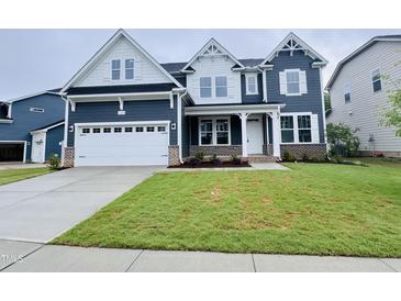 Charming two-story home with a beautifully landscaped front yard and a two car garage at 3529 Bailey Lake Dr, Fuquay Varina, NC 27526