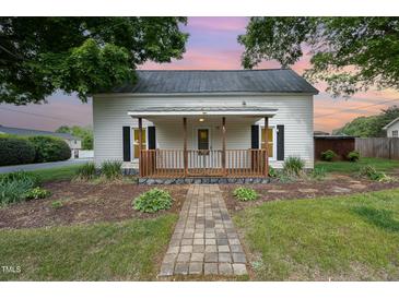 Charming home featuring a covered front porch with decorative wood railing at 510 May St, Gibsonville, NC 27249