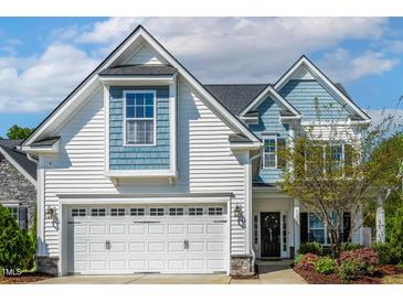 Charming two-story home featuring a two-car garage and landscaped front yard at 5172 Copain Cove, Fuquay Varina, NC 27526
