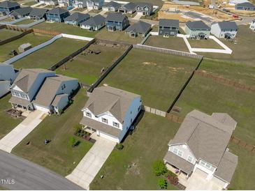 An aerial view displays the new construction homes with expansive lots in a Gathering-friendly neighborhood at 76 Arlie Ln, Lillington, NC 27546