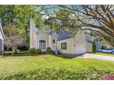Charming home featuring a well-manicured lawn and inviting curb appeal, with mature trees at 8629 Swarthmore Dr, Raleigh, NC 27615