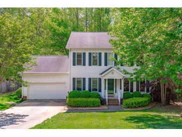 Charming two-story home with green shutters, landscaped yard, and attached two-car garage at 107 Candy Apple Ct, Cary, NC 27513