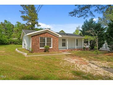 Charming single-story home with white siding and brick accents, surrounded by a green lawn at 108 Deepwood Cir, Garner, NC 27529