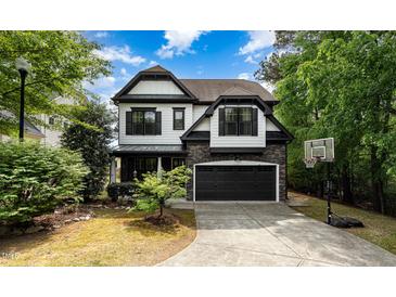 Charming two-story home with a stone-accented garage and well-manicured front yard at 1209 Shasta Daisy Dr, Wake Forest, NC 27587