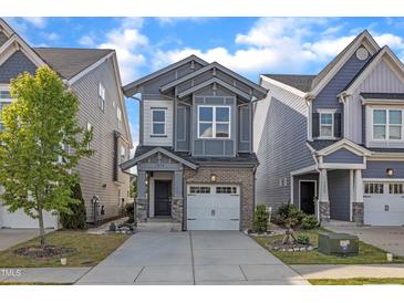 Charming two-story home with a well-manicured lawn, a driveway, and an attached garage at 1272 Brown Velvet Ln, Apex, NC 27523