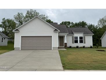Charming single-story home featuring a gray garage door, light gray siding, and a well-manicured lawn at 139 Oakfield Trace Dr, Four Oaks, NC 27524