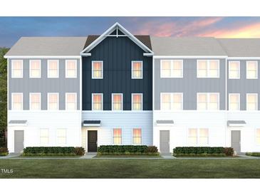 Beautiful townhome featuring varying colors, green lawn, and covered doorways for an inviting place to live at 1486 Hasse Ave, Apex, NC 27502