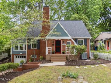 Charming brick home with a well-manicured front yard and inviting entrance, perfect for a cozy Gathering at 1809 Glendale Ave, Durham, NC 27701