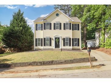 Charming two-story home with a well-maintained front yard and classic architectural details at 1832 Elkpark Dr, Raleigh, NC 27610