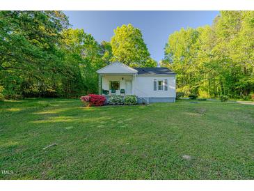 Charming home with a well-manicured lawn, mature trees, and curb appeal at 2021 Bundy Ave, Durham, NC 27704