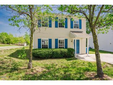 Charming two-story home with blue shutters and a well-manicured front lawn at 2032 Lime St, Durham, NC 27704