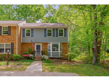 Charming two-story townhouse with a well-maintained yard, brick accents, and beautiful blue shutters at 225 Bay Dr, Cary, NC 27511