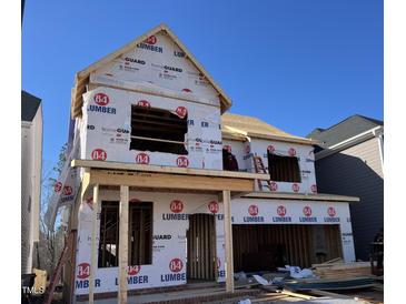 Two-story home under construction, showing wood framing and protective wrap, ready for customization at 2434 Barreto Dr, Wendell, NC 27591