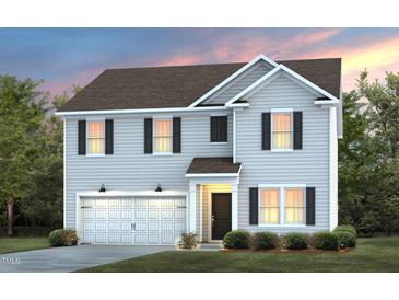 Charming two-story home featuring a gabled roof, black shutters and a front-facing two car garage at 3227 Pelican Ln, Durham, NC 27703
