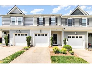A charming townhouse with a one-car garage and well-manicured landscaping at 412 Stone Flower Ln, Raleigh, NC 27603