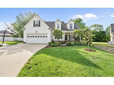 Charming two-story home with a well-manicured lawn, basketball goal, and an attached two-car garage at 45 Mill Cir, Clayton, NC 27527