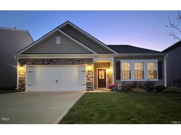 Charming single-Gathering home showcasing a stone-accented facade, inviting entryway, and well-maintained landscaping at 46 S Great White Way, Clayton, NC 27527