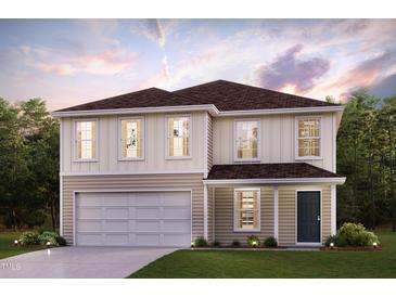 Charming two-story home with an attached garage and well-manicured lawn, blending comfort and curb appeal seamlessly at 5015 Harrier Ln, Snow Camp, NC 27349