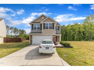 Charming two-story home featuring a two-car garage, stone accents, and a well-maintained front yard at 536 Gusty Ln, Zebulon, NC 27597