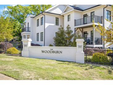 Elegant white brick sign reading 'The Woodburn' at a stylish, gated community entrance at 607 Smedes Place # B, Raleigh, NC 27605