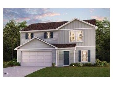 Charming two-story home features a two-car garage, gray siding, and a well-manicured lawn at 7008 Peppermill Way, Rocky Mount, NC 27804