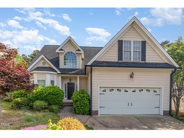 Charming two-story home featuring a well-maintained lawn, a two-car garage, and a classic front facade at 7940 Milltrace Run, Raleigh, NC 27615