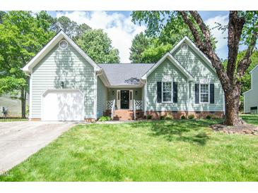 Charming one-story home with a well-maintained lawn, attached garage and beautiful green surroundings at 101 Lakeshore Dr. Dr, Durham, NC 27713