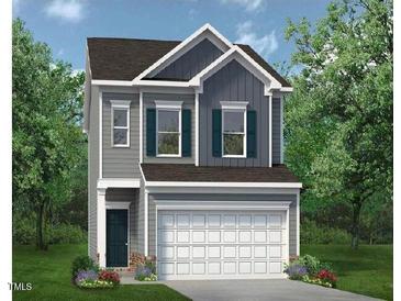Two-story home with gray siding, attached two-car garage, and manicured lawn surrounded by mature trees at 152 Bruce Drive Dr, Dunn, NC 28334