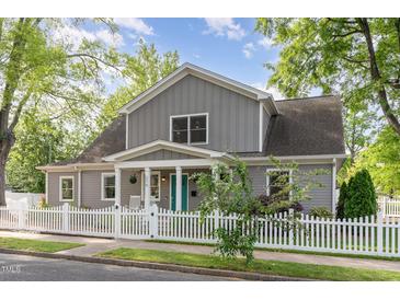 Charming two-story home with gray siding, white trim, and a welcoming front porch and a nice white picket fence at 219 Northwood Cir, Durham, NC 27701