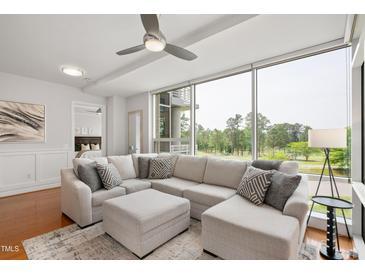 Bright living room featuring sectional sofa, ottoman, and a large window providing scenic views at 2202 Environ Way # Bldg 2000, Chapel Hill, NC 27517