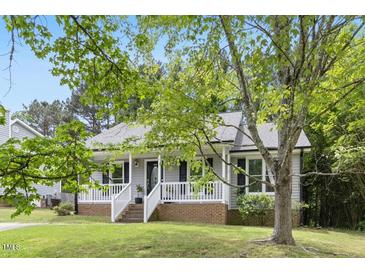 Charming home featuring a welcoming front porch and well-maintained landscaping at 2402 Cynthia Dr, Durham, NC 27704