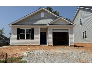 Charming single-story home featuring light siding, black shutters, and an attached garage, ready for new owners at 245 Bluejay St, Clayton, NC 27520