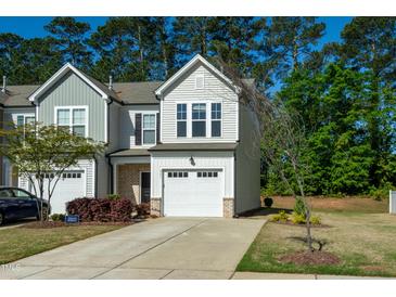 Charming townhome featuring a one car garage and a well maintained lawn at 261 White Oak Ridge Dr, Garner, NC 27529