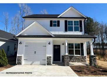 Charming two-story home with a one car garage, stone accents, and a covered front porch at 263 Bluejay St, Clayton, NC 27520