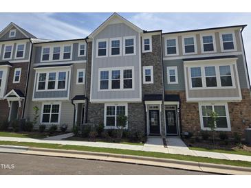 Attractive new townhome exterior with stone accents and manicured landscaping at 3020 Freewinds Way # 47, Cary, NC 27519